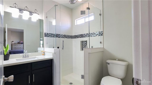 full bathroom featuring a shower stall, vanity, ensuite bathroom, and toilet