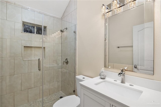 bathroom featuring a shower with door, vanity, and toilet