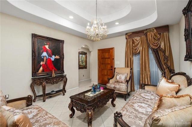 sitting room featuring a raised ceiling and light tile patterned flooring