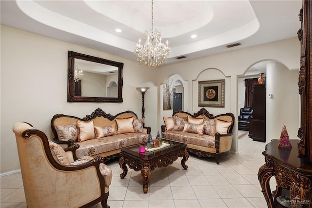 living room featuring light tile patterned floors and a tray ceiling