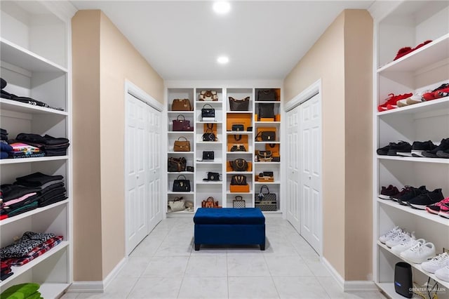 spacious closet with light tile patterned floors