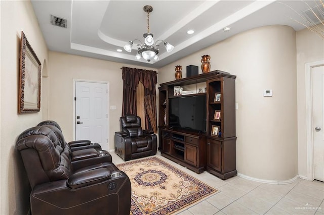 tiled living room with a raised ceiling and an inviting chandelier