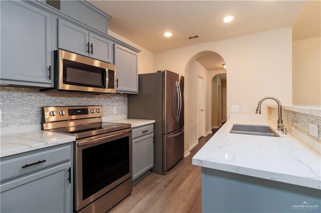 3707 Alvarado St, Edinburg, TX 78539 - kitchen featuring stainless steel appliances, gray cabinets, light stone countertops, and recessed lighting