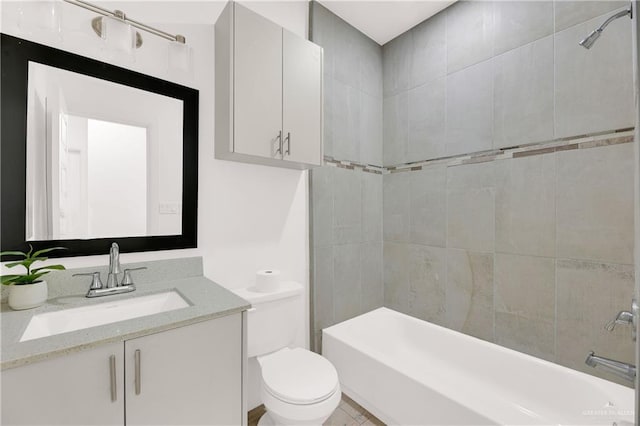 full bathroom featuring tiled shower / bath combo, toilet, and vanity