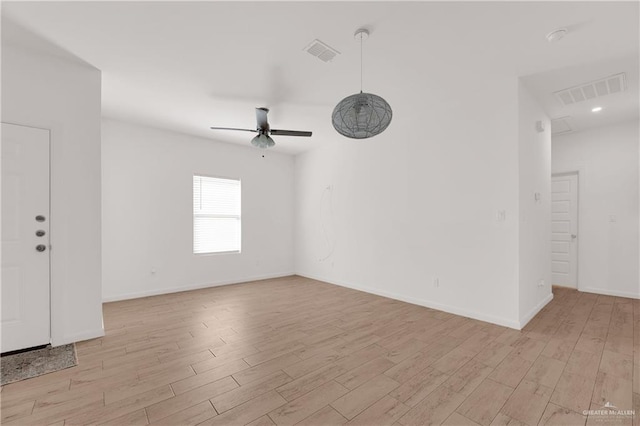 spare room featuring ceiling fan and light wood-type flooring