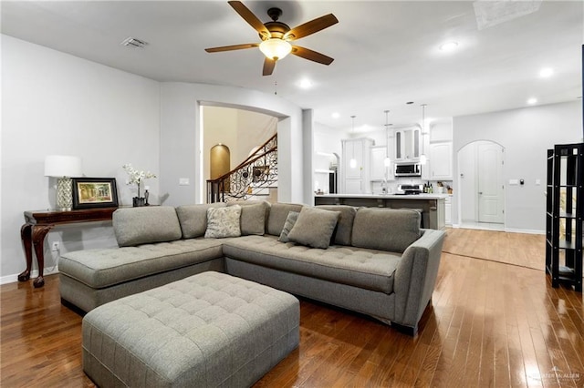 6614 Mile 7 Rd, Mission, TX 78573 - living room featuring arched walkways, a ceiling fan, light wood-type flooring, and recessed lighting