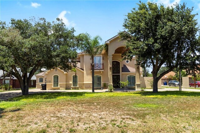 6614 Mile 7 Rd, Mission, TX 78573 - mediterranean / spanish-style house featuring stucco siding, a front yard, and a balcony