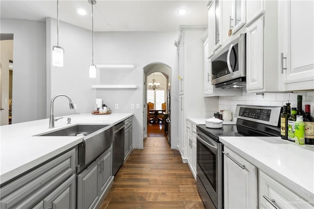 6614 Mile 7 Rd, Mission, TX 78573 - kitchen with stainless steel appliances, a sink, arched walkways, light countertops, and recessed lighting
