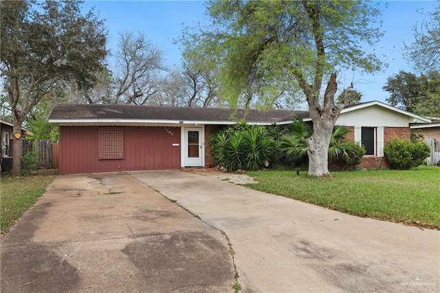 ranch-style home with a front lawn and fence