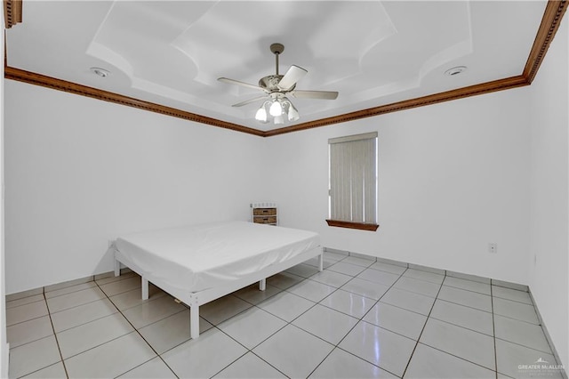 unfurnished bedroom with a raised ceiling, ceiling fan, crown molding, and light tile patterned floors