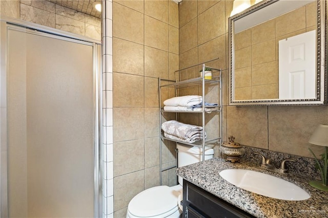 2315 E Sprague St, Edinburg, TX 78542 - bathroom featuring tile walls, vanity, toilet, and a stall shower