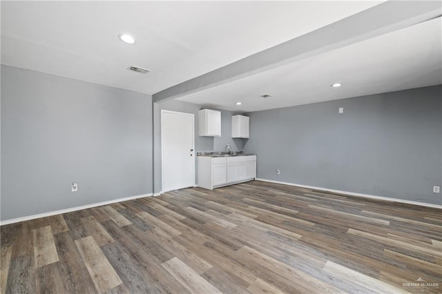 2315 E Sprague St, Edinburg, TX 78542 - unfurnished living room with a sink, wood finished floors, visible vents, recessed lighting, and baseboards
