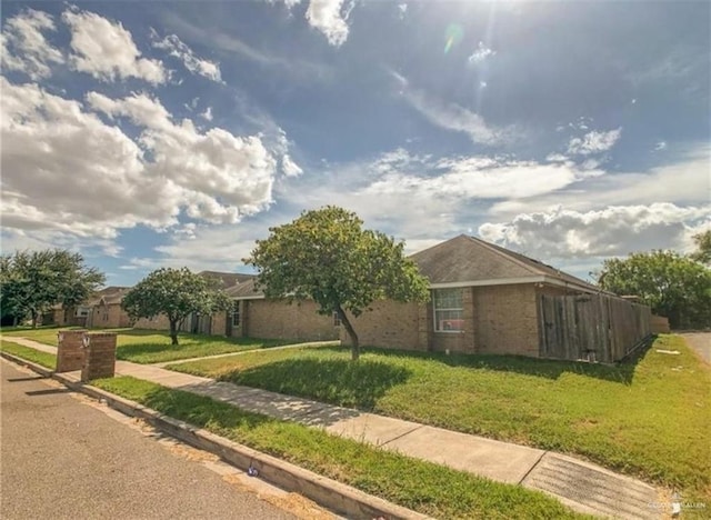 ranch-style home featuring a front yard