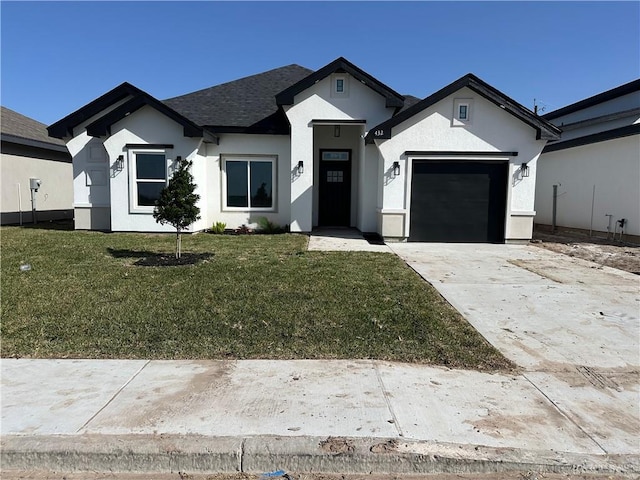 view of front of house featuring a garage and a front yard