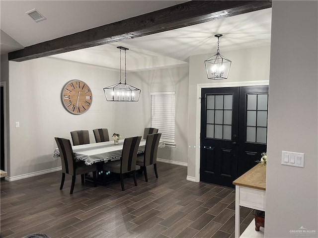 dining space featuring beamed ceiling, french doors, and a notable chandelier