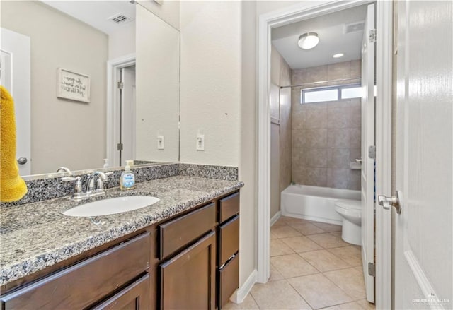 full bathroom featuring tile patterned flooring, vanity, toilet, and tiled shower / bath combo