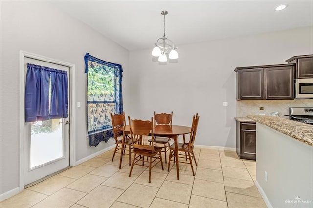 dining room with a chandelier and light tile patterned flooring