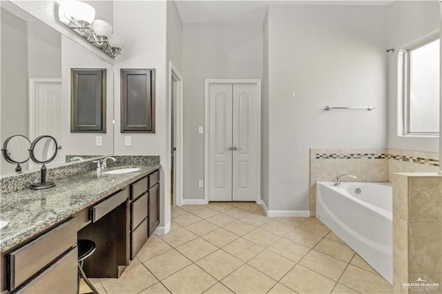 bathroom featuring a bathing tub, tile patterned flooring, and vanity