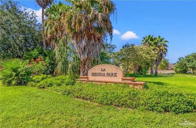 community sign featuring a yard