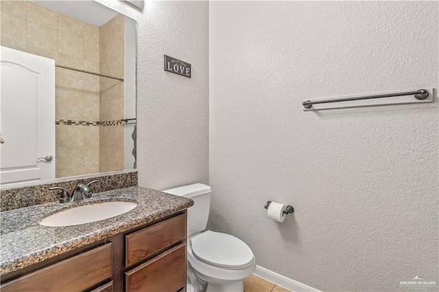 bathroom featuring tile patterned flooring, vanity, and toilet