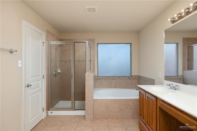 bathroom featuring tile patterned floors, vanity, and plus walk in shower