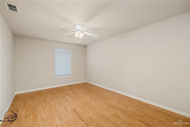 spare room with light wood-type flooring and ceiling fan