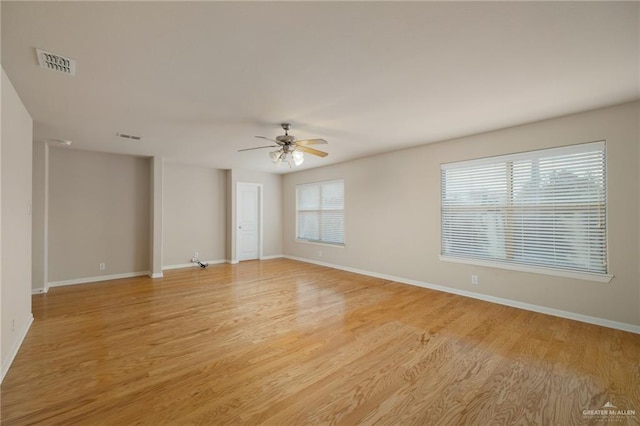 spare room featuring light hardwood / wood-style flooring and ceiling fan