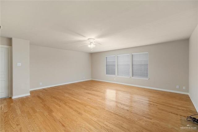 empty room featuring light wood-type flooring and ceiling fan