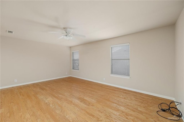 empty room featuring ceiling fan and light hardwood / wood-style flooring