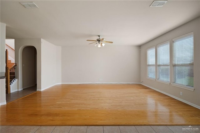 empty room with ceiling fan and light wood-type flooring