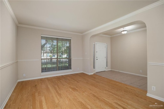 empty room featuring light hardwood / wood-style floors and crown molding