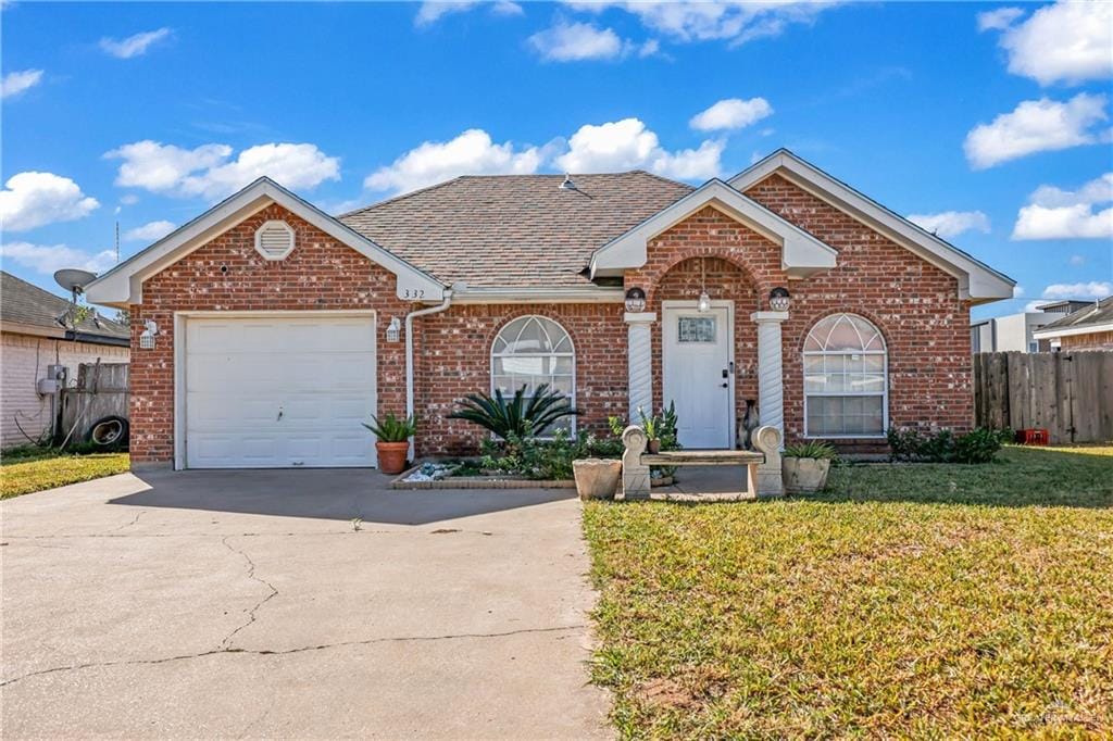 view of front of home with a front lawn and a garage