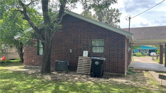 view of side of property featuring a lawn and cooling unit