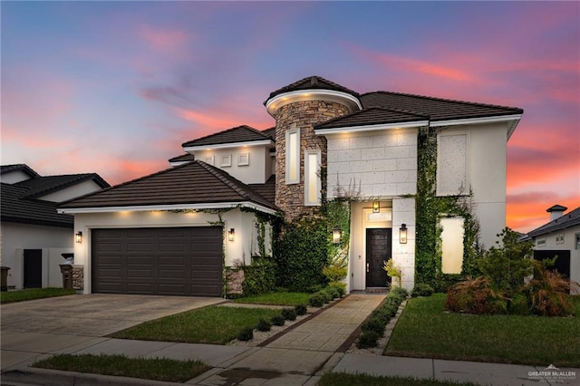 view of front facade featuring stone siding, a tiled roof, concrete driveway, and a garage