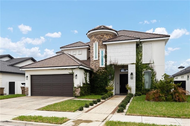 view of front of property with a tile roof, driveway, stucco siding, and an attached garage