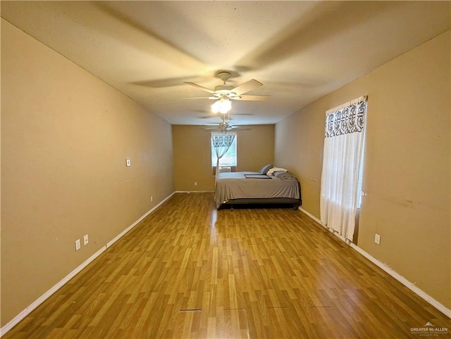 unfurnished bedroom featuring ceiling fan and light wood-type flooring