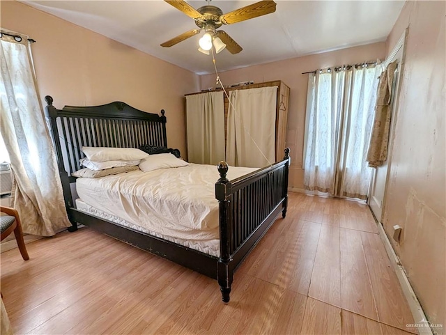 bedroom with hardwood / wood-style flooring and ceiling fan