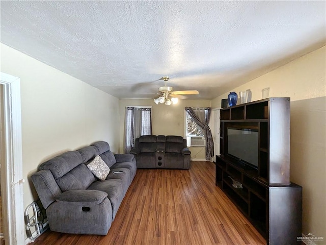 living room with ceiling fan, hardwood / wood-style floors, and a textured ceiling