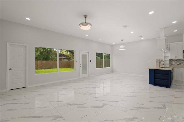 9218 N 25th St, Mcallen, TX 78504 - unfurnished living room with recessed lighting, baseboards, and light marble finish floors