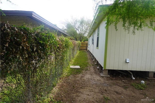 view of home's exterior with fence