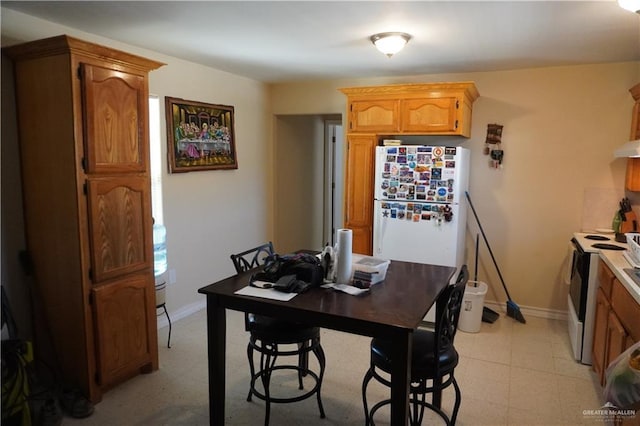 dining room featuring light floors and baseboards