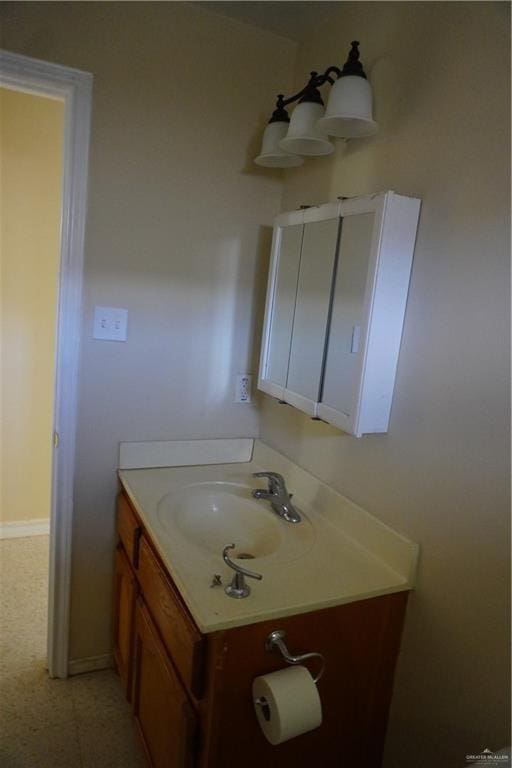 bathroom featuring baseboards and vanity