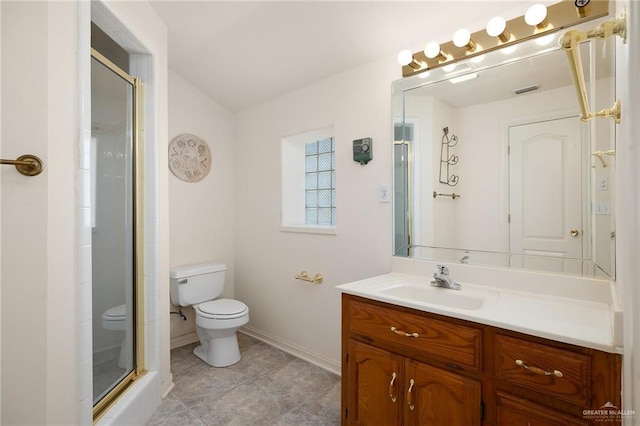 bathroom with tile patterned floors, vanity, toilet, and walk in shower