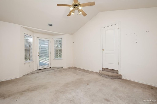 carpeted empty room with ceiling fan and lofted ceiling