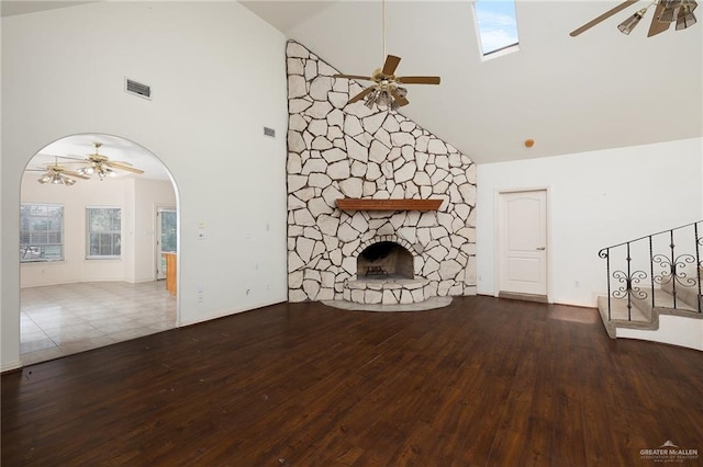 unfurnished living room with a fireplace, hardwood / wood-style floors, and high vaulted ceiling