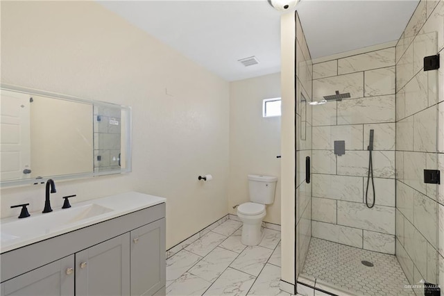 bathroom featuring vanity, a shower with shower door, and toilet