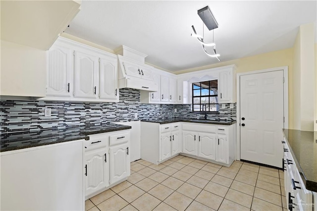 kitchen featuring white cabinetry, sink, decorative backsplash, and light tile patterned floors