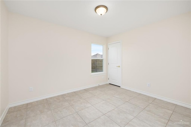 unfurnished room featuring baseboards