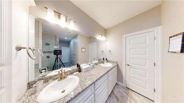 1003 Pear St W, Pharr, TX 78677 - full bathroom featuring lofted ceiling, a tile shower, double vanity, and baseboards