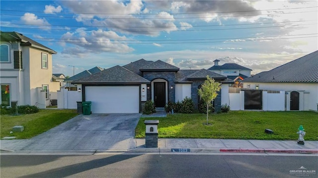1003 Pear St W, Pharr, TX 78677 - view of front facade featuring concrete driveway, an attached garage, and a front yard